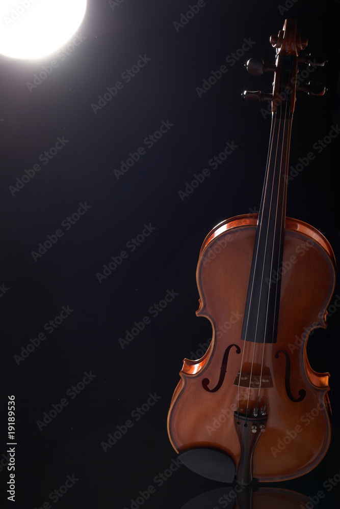 beautiful vintage violin over dark background