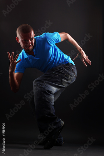 cool modern dancer in action against black background