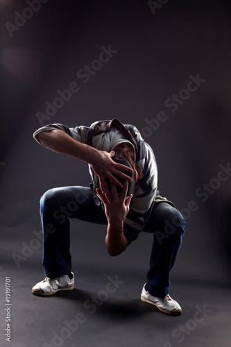 Hip hop man dancer against black background