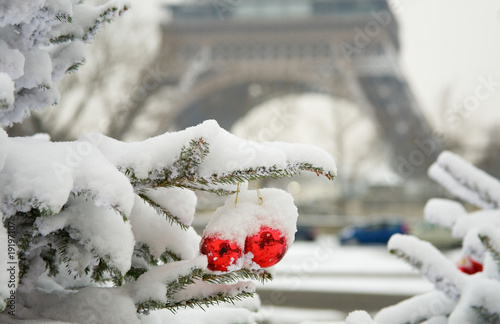 Photography Rare snowy day in Paris. Decorated Christmas tree and the Eiffel