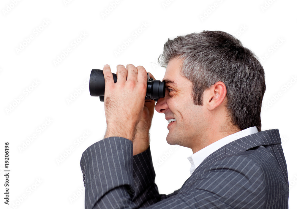 Charismatic businessman using binoculars Charismatic businessman using binoculars