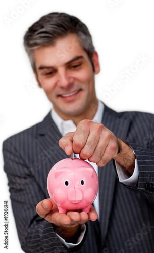 Confident Businessman saving money in a piggybank