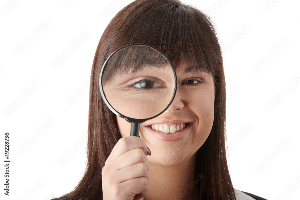 business woman looking into a magniying glass business woman looking into a magniying glass