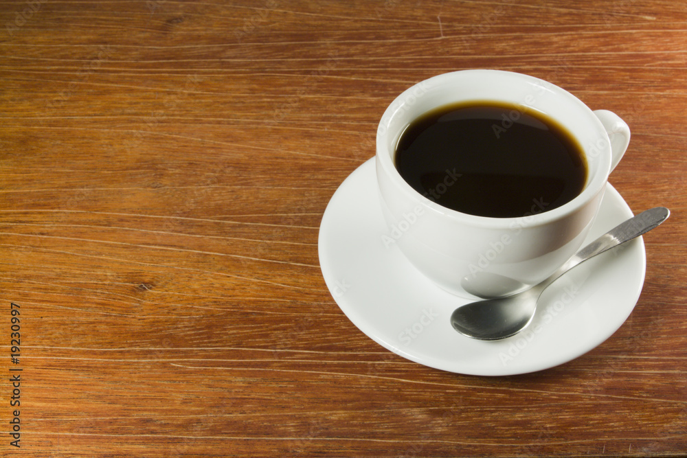 Coffeecup with Coffee in it on a wooden table