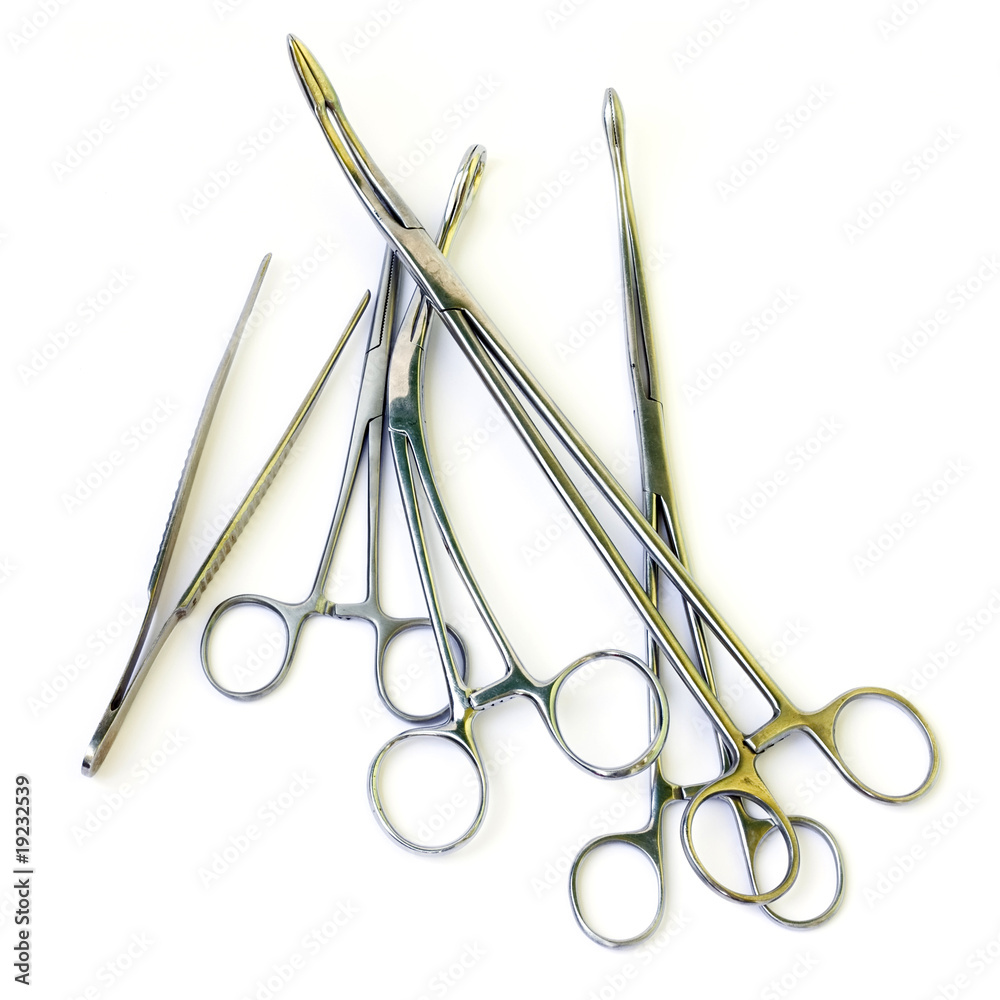 Stacked surgical instruments isolated over white Stacked surgical instruments isolated over white