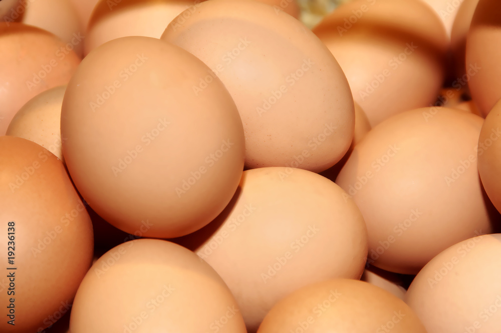 a closeup of a pile of brown eggs