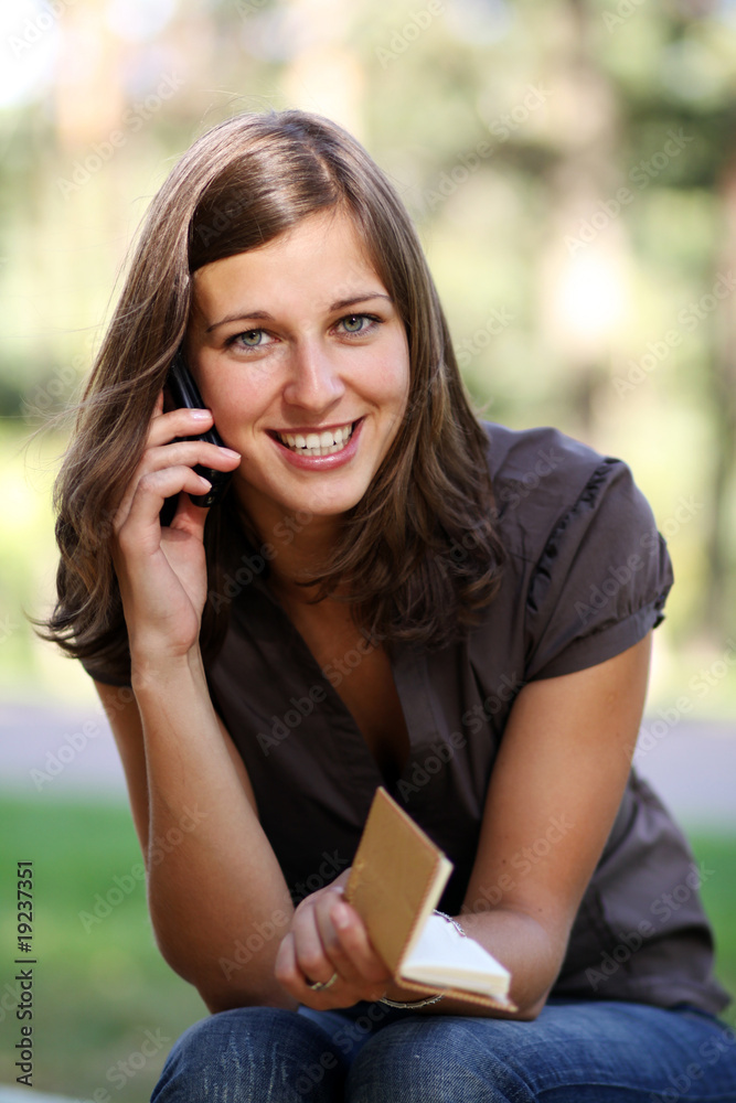 Happy young lady talking on mobile phone Happy young lady talking on mobile phone