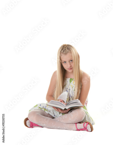 Little blonde girl reading a book