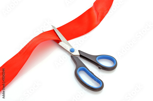 Red ribbon with scissors isolated on white