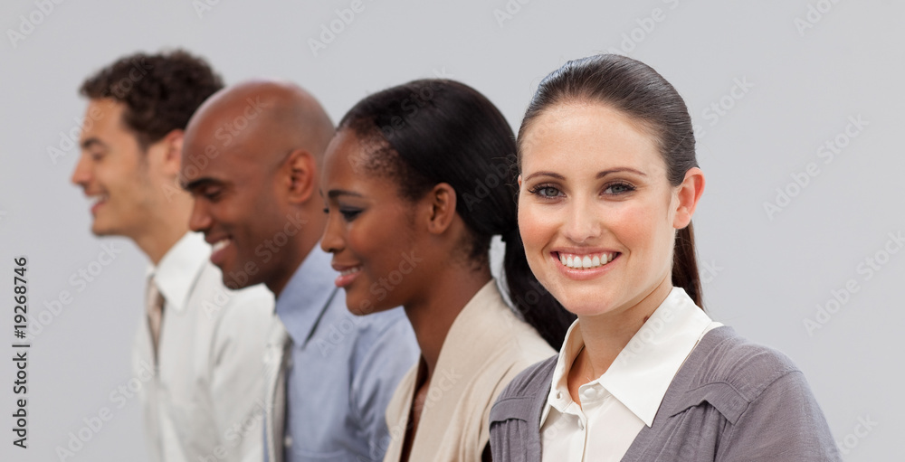 Diverse young business people sitting in a line Diverse young business people sitting in a line