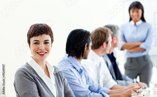 Attractive businesswoman in a meeting with her colleagues