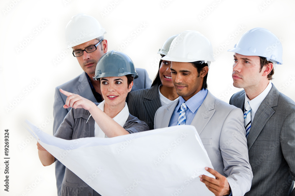 A diverse group of architects studying a plan A diverse group of architects studying a plan
