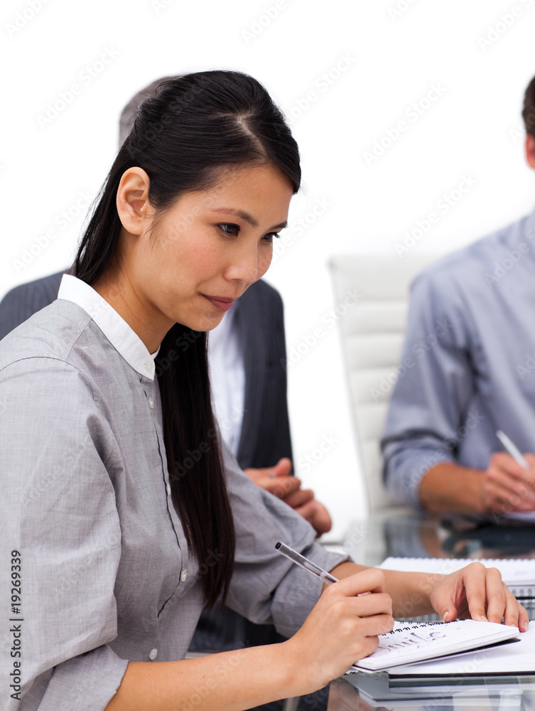 Concentrated female executive studying a document Concentrated female executive studying a document