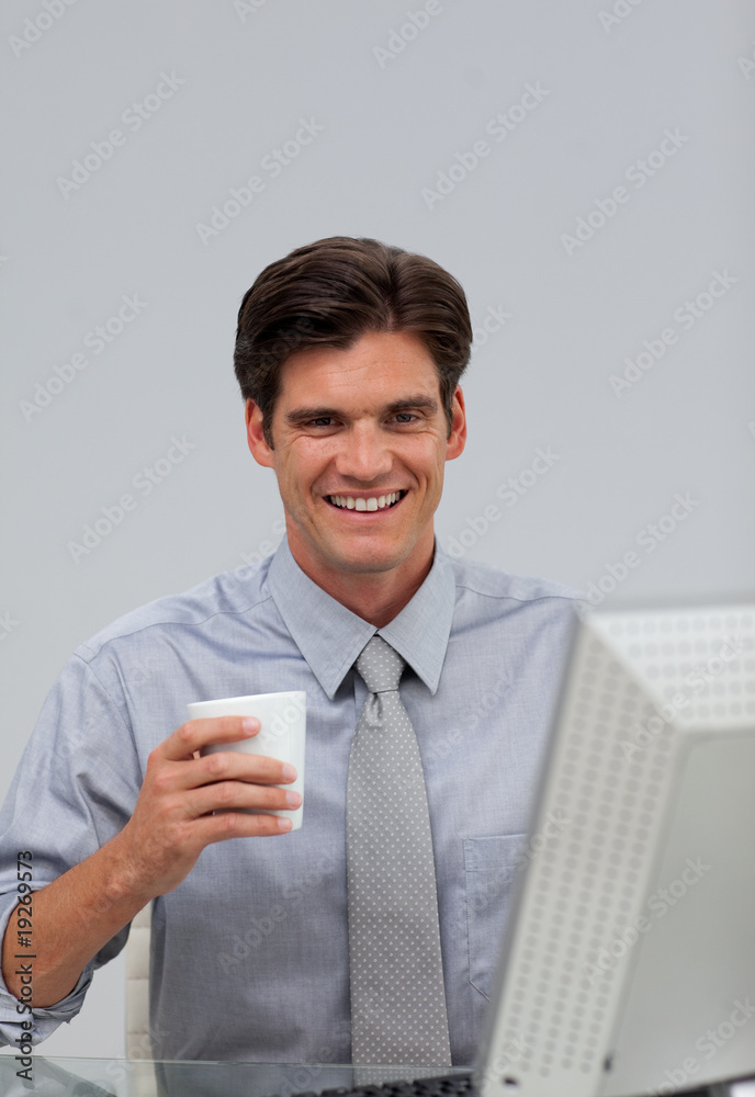 Happy caucasian businessman holding a drinking cup Happy caucasian businessman holding a drinking cup