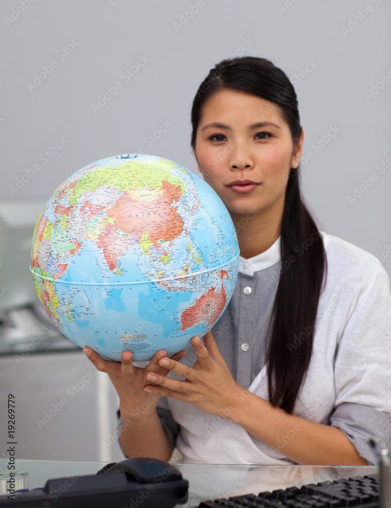 Charming asian businesswoman holding a globe Charming asian businesswoman holding a globe