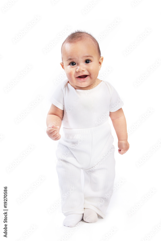 Infant baby dressed in white standing isolated Infant baby dressed in white standing isolated