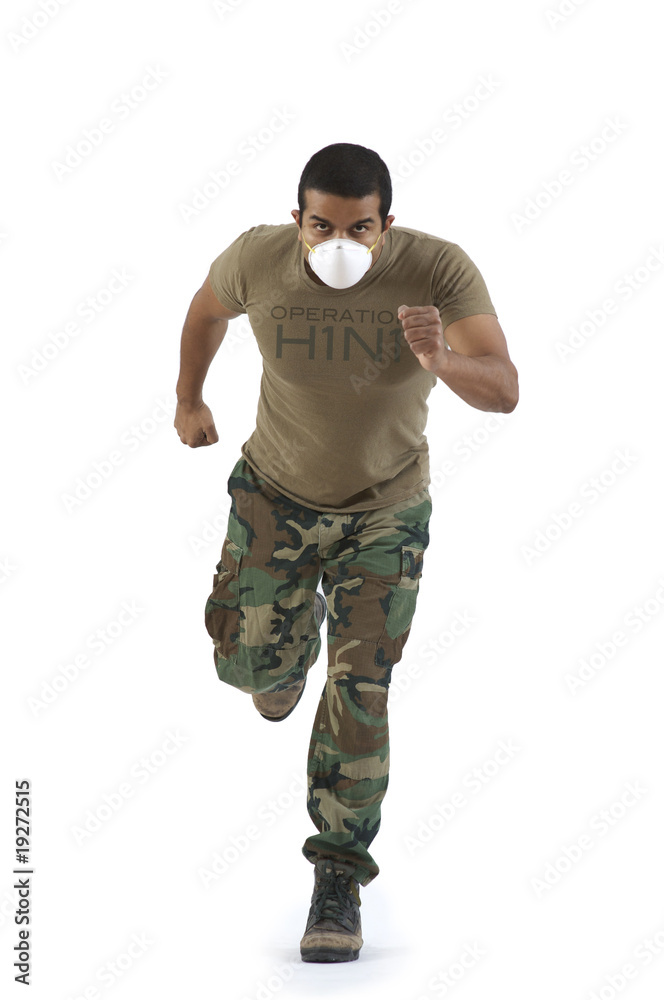 Military man in camouflage running with H1N1 mask Military man in camouflage running with H1N1 mask