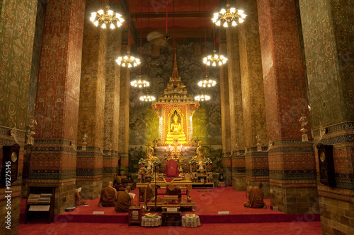 Monks  praying in Buddhist church photo