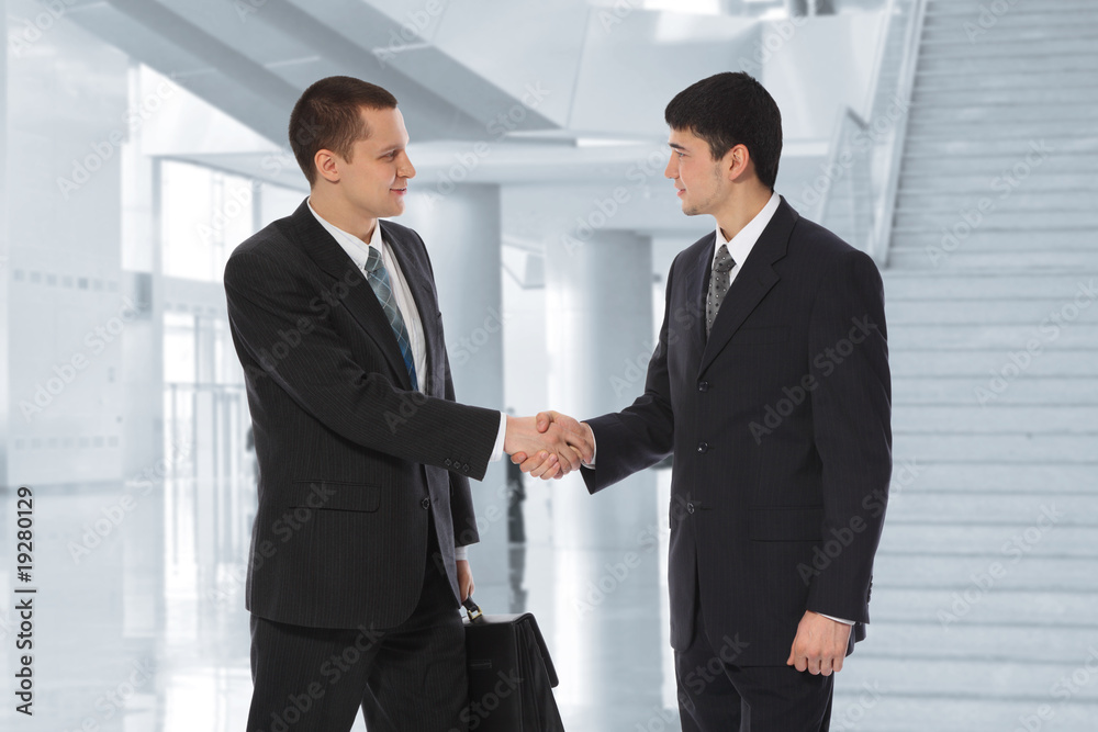 Two young businessmen greet in business centre collage Two young businessmen greet in business centre collage