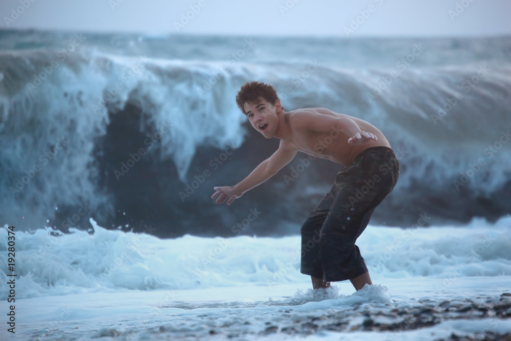 teenager escaping from sea wave