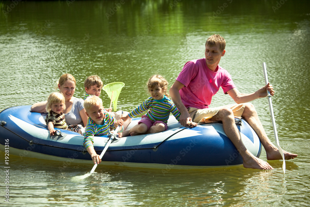 Children and adults float on an inflatable boat and fish a net. Children and adults float on an inflatable boat and fish a net.