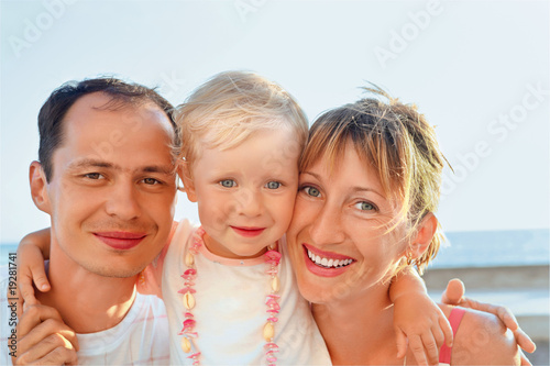Happy family with little near to sea