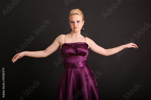 Beautiful young woman in violett dress