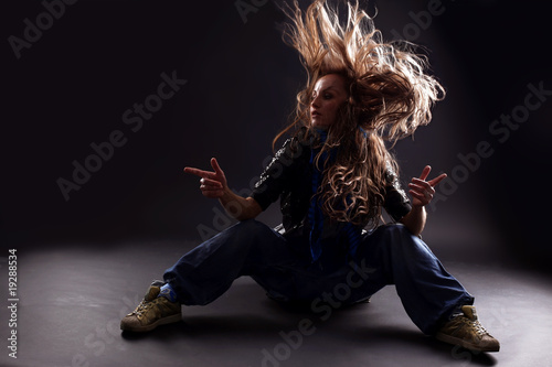 cool woman dancer against black background photo