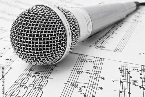 classical microphone on sheet of notes