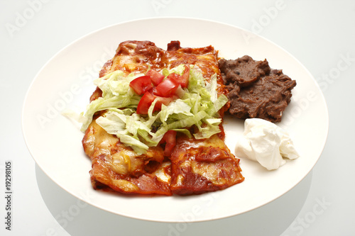 Plate of enchiladas and refried beans.