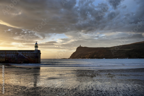 Low tide at Port Erin Bay Pier and Brada Head at dawn
