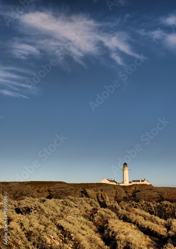 Blue sky with cirrus clouds over lighouse on the Isle of Man