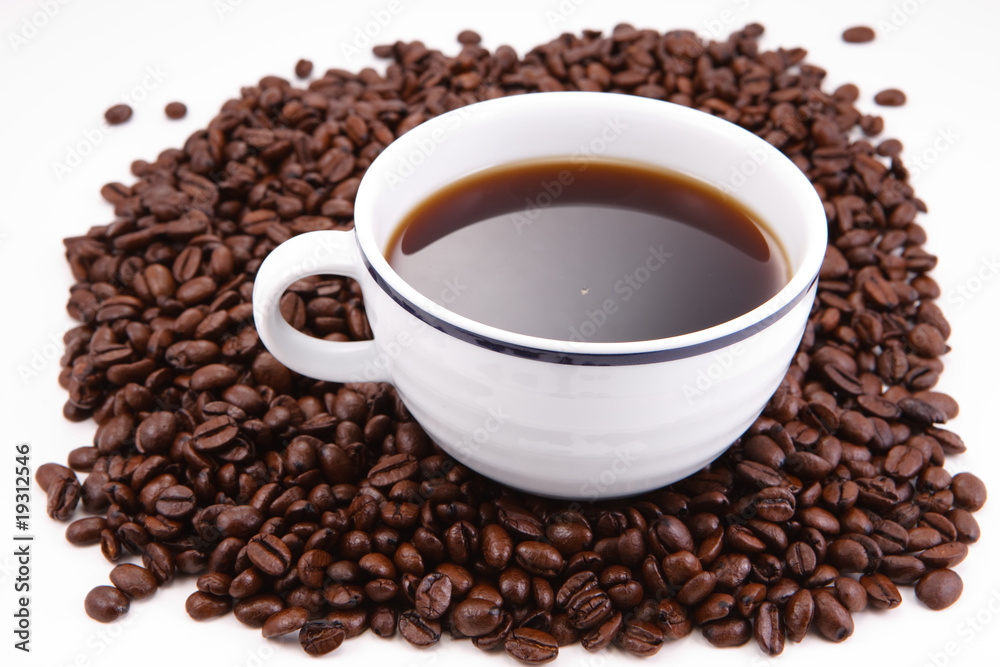 Cup of coffee sitting in a bed of coffee beans Cup of coffee sitting in a bed of coffee beans