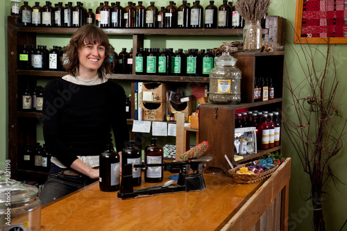 A smiling shop owner welcomes customers