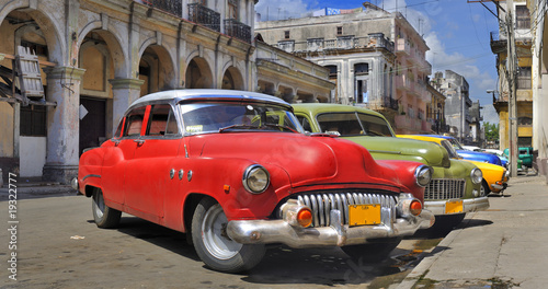 Havana street with colorful old cars in a raw #19322777