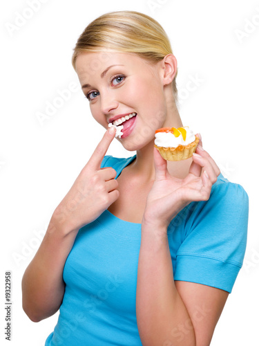 Attractive woman eats sweet white cream