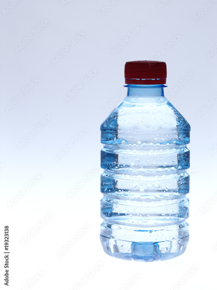 Cold spring water in the bottle with water droplets