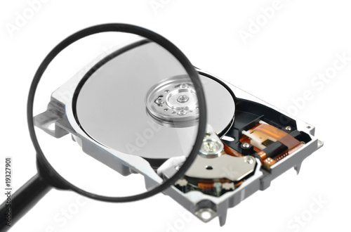 Magnifying glass over a computer harddrive