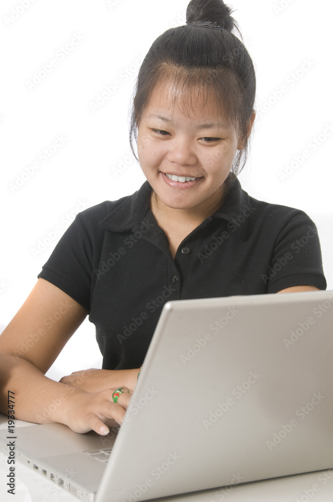 Student sitting down at desk with computer Student sitting down at desk with computer