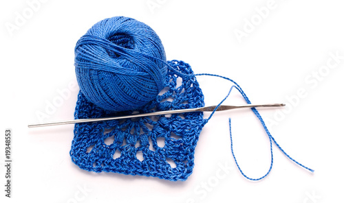 A ball of blue yarn with knitting and crochet pattern crochet