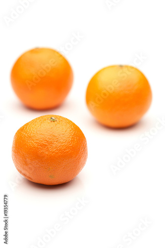 three tangerines on white