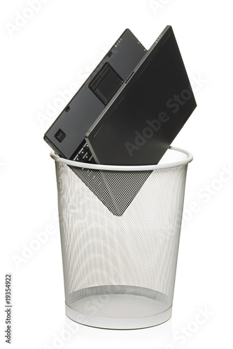 Laptop in a trash bin isolated against white background
