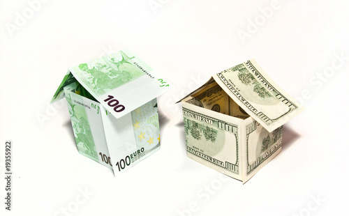 Housea made from euro and dollar bills on white background photo