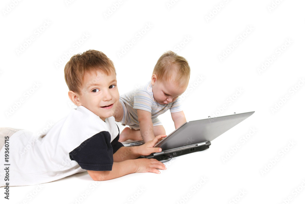 two children with laptop over white
