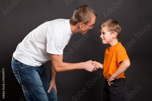 Shakes hands