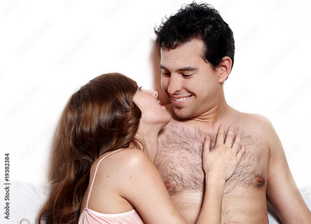 intimate young couple during foreplay in bed intimate young couple during foreplay in bed
