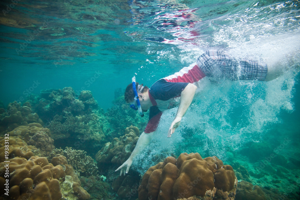 Snorkeling guy under the water