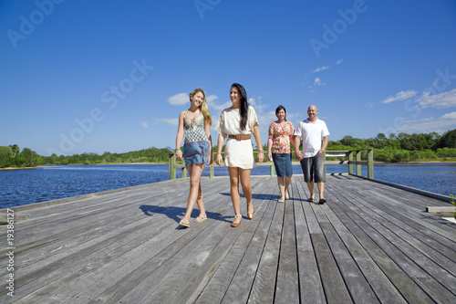 family walking on viewing platform by the creek