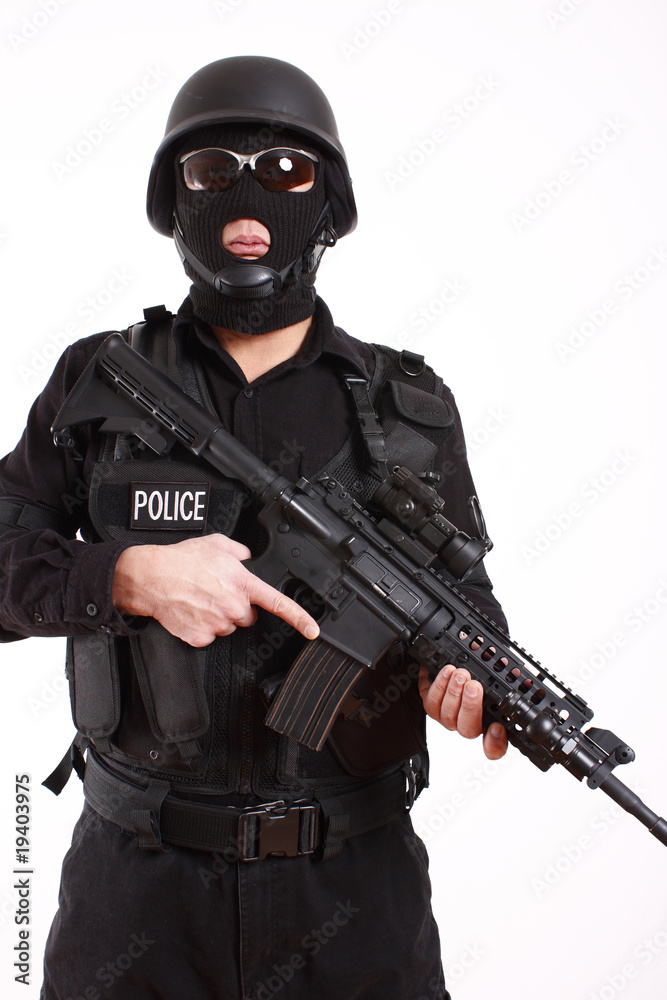 SWAT police officer with assault gun. SWAT police officer with assault gun.