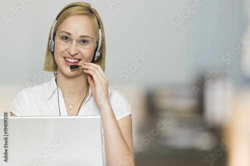 young businesswoman with headset in office room